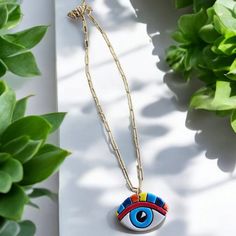 Introduce a splash of color and symbolism to your jewelry collection with our Stainless Steel Chain Necklace featuring a Handmade Ceramic Rainbow Eye Pendant. This striking necklace showcases a beautifully crafted ceramic eye, meticulously handmade and painted with vibrant rainbow colors. Each piece is unique, making it a truly special addition to any wardrobe. The eye pendant, a symbol of protection and positive energy, is delicately suspended from a sleek stainless steel chain. The chain's durable and hypoallergenic properties ensure that this necklace is both stylish and comfortable for everyday wear. This necklace is perfect for adding a bold statement to your look, whether you're dressing up for a special occasion or adding a touch of flair to your casual attire. The combination of th Multicolor Evil Eye Necklace For Gift, Multicolor Evil Eye Necklace As Gift, Multicolor Spiritual Charm Necklaces For Gift, Artsy Multicolor Round Pendant Necklace, Colorful Pendant Jewelry As A Gift, Personalized Multicolor Pendant Necklaces, Artsy Multicolor Round Pendant Jewelry, Personalized Multicolor Pendant Necklace, Multicolor Pendant Charm Necklace As Gift