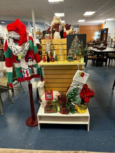 christmas decorations are on display in an office setting with santa claus and other holiday items