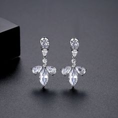 Accent your ears with the shining style of these floral stud earrings featuring cubic zirconia embellishments. 0.55" W x 1.02" L Silver-plated copper / crystal / cubic zirconia Copper Crystal, Floral Studs, The Shining, Accessories Jewelry Earrings, Apparel Accessories, Silver Plate, Silver Plated, Cubic Zirconia, Embellishments