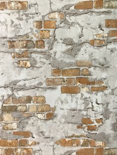 an old brick wall with peeling paint and chippings on the bricks is shown