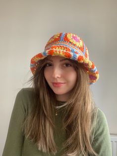 a woman with long hair wearing a colorful hat