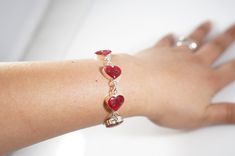 Beautiful sterling silver bracelet made with real flowers in heart shaped resin. Heart Beads Resin Jewelry Gift, Resin Bracelets As Gifts, Sterling Silver Heart Bracelets As Gift For Her, Elegant Red Charm Bracelet With Heart Charm, Heart-shaped Resin Jewelry For Valentine's Day, Heart Shaped Resin Jewelry For Valentine's Day, Valentine's Day Heart-shaped Resin Jewelry, Red Heart-shaped Elegant Charm Bracelet, Red Heart Bracelets For Anniversary