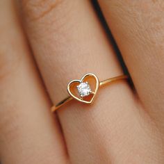 A pretty 0.07ct round brilliant diamond, set inside a heart silhouette, this ring is crafted in 14k solid gold and is a treat to the eyes and heart. * Diamond Wt. : 0.07 Cts * Color-Clarity Grade : H-I - Vs-Si * Gold - 14kt, 1.2 gms Solid Yellow Gold Find us on Instagram for exquisite designs: @abhikajewels Like us on Facebook: www.facebook.com/Abhikajewels Thank you for visiting our shop.. :) Heart Shape Ring Design, Heart Shape Ring Design Gold, Diamond Heart Ring For Promise Occasions, Heart-shaped Diamond Birthstone Promise Ring, Diamond Heart Shaped Promise Ring, Fine Jewelry Heart Shaped Single Diamond Ring, Heart Shaped Single Diamond Fine Ring, Heart Shaped Single Diamond Ring Fine Jewelry, Heart Shaped Single Diamond Ring