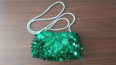 This is the perfect little evening bag for a formal event. It's covered entirely with sequins and beads. It's an amazing kelly green color and has an attached light green braided strap. The strap is not meant to be concealed inside the purse, since it's sewn outside of the zipper. The interior is spotless and there is a brand tag for Magid.  It measures 8" wide x 4" high x 25.5" with the strap. The only imperfection I see is that there is one small beaded strand that is loose near the top zipper Rectangular Sequined Shoulder Bag For Party, Embellished Green Evening Shoulder Bag, Green Embellished Evening Shoulder Bag, Glamorous Formal Shoulder Bag With Sequins, Rectangular Sequined Party Shoulder Bag, Sequin Clutch Bag For Gift, Green Beaded Evening Bag For Party, Green Beaded Bag For Party, Green Beaded Bags For Parties