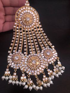 A classy and trendy big size kundan jhumar to uplift your look! Add a little extra sparkle to your wedding look with this beautiful head piece embellished with kundan stones! In stock and ready to ship. Pakistani Mangtika, Luxury Kundan Tikka With Cutdana Details, Luxury Temple Jewelry Tikka With Meenakari, Luxury Elegant Tikka With Stone Work, Luxury Stone Work Tikka For Reception, Luxury Stone Work Tikka For Celebration, Bollywood Style Kundan Tikka, Bollywood Style Hand Set Tikka For Festivals, Kundan Tikka With Stone Work For Festivals