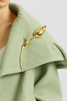 One of the key motifs within the AW24 collection, this single bud on an elegantly curved stem is inspired by the flowers thrown on stage at the end of Maria Callas' opera performances. This brooch is crafted from antique gold. Fix it on your coat or dress for a hint of subtle shimmer. Wear with Opera Coat | Powder Green All accessories are considered final sale and may not be returned or exchanged. Luxury Gold Brooch Lapel Pin, Elegant Gold Flower Lapel Pin, Gold Flower Brooch For Evening, Elegant Gold Flower Brooch, Elegant Gold Flower Brooches, Elegant Rose Gold Lapel Pin Brooch, Luxury Gold Lapel Pin For Evening, Opera Coat, Maria Callas