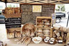 breads and pastries are on display at an outdoor vendor's market stall