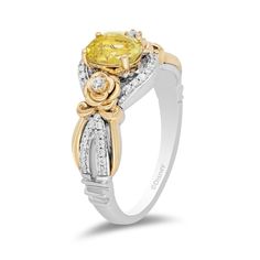 Sophisticated with a whimsical touch from the Enchanted Disney Fine Jewelry Collection, this yellow quartz and diamond ring commemorates the 30th anniversary of Disney's animated Beauty and the Beast. Fashioned in sterling silver and warm 10K gold This romantic look features a 7.0 x 5.0mm oval-shaped lemon-yellow quartz gleaming between diamond-lined silver ribbons and flanked by diamond-touched gold blooms. Along the split shank, polished gold ribbons highlight inner rows of diamonds set in silver while crown insets are the final detail. This design sparkles with 1/5 ct. t.w. of diamonds. A Certificate of Authenticity accompanies this collector's edition piece. Available in size 7 only. ©Disney Enchanted Disney, Enchanted Disney Fine Jewelry, Yellow Quartz, Platinum Jewelry, Disney Beauty And The Beast, Romantic Look, Yellow Stone, Gold Ribbons, 30th Anniversary