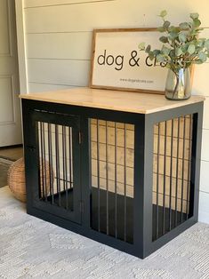 a dog crate sitting on top of a rug next to a vase filled with flowers