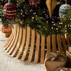 christmas tree with wooden slats and presents under it