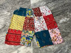 "Handmade Product Unisex Assorted Patchwork Shorts / Bohemian Comfy Summer Shorts / Beach Wear Cotton Patchwork Short / Night Wear Shorts / Yoga Shorts This patchwork short was made to look cool in summers, It is handmade with different patterns. It comes with comfortable elastic waist and ankle. These are made perfect for a relaxing day at home, working out, yoga. Made with 100% cotton fabric. Important Note :- As it is patchwork product so you will receive variation in patches for each piece. Multicolor Floral Patchwork Bottoms For Summer, Multicolor Patchwork Beach Pants, Multicolor Floral Patchwork Summer Bottoms, Summer Multicolor Floral Patchwork Bottoms, Summer Floral Patchwork Multicolor Bottoms, Multicolor Patchwork Pants For Loungewear, Multicolor Patchwork Bottoms For Loungewear, Red Patchwork Bottoms For Summer, Red Patchwork Summer Bottoms