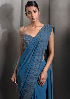 Draped pre-stitched tulle sari embellished with tonal embroidery with matching embroidered blouse. Semi-stitched Embellished Blue Blouse Piece, Semi-stitched Embellished Blue Saree, Blue Bollywood Embellished Pre-draped Saree, Blue Embellished Floor-length Saree, Embellished Blue Saree For Diwali, Festive Blue Embellished Pre-draped Saree, Blue Embellished Saree With Traditional Drape, Blue Embellished Semi-stitched Pre-draped Saree, Blue Resham Embroidery Blouse For Evening