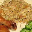 a white plate topped with meat and veggies next to a pile of rice