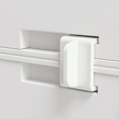 a white door handle is attached to the side of a refrigerator