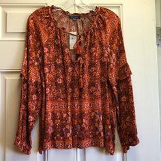 American Eagle Outfitters Bohemian Top. Size Medium. Rust Colored With Mustard And Cream Colored Flowers With Hints Of Royal Blue. No Damage. No Stains. 100% Viscose. Made In India. Wrists Are Elasticized. Collar Does Not Have Elastic. Ruffle At Elbows. No Stretch. Measures: 26”L, Hip 23.5” Wide From Seam To Seam. Measurement Was At Very Bottom Of This Blouse. Pit To Pit 22”, Waist Measures 23” Lying Flat. Tags: Casual, Fringe, Bohemian, Hippie, Free, Peace, Love, Pink, Autumn, Fall India Indian Pink Autumn, Bohemian Top, Bohemian Tops, Colored Flowers, Bohemian Hippie, Boho Top, Rust Color, Peasant Tops, Boho Blouses