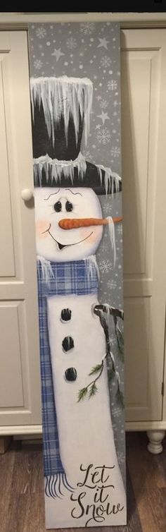 a snowman painted on the side of a kitchen door