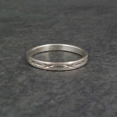 This beautiful vintage Italian band ring is sterling silver with a diamond cut design. Measurements: 3mm wide Size: 7 Marks: Milor, 925 Condition: Excellent Classic Silver Band Ring, Formal Silver Band With Diamond Cut, Formal Silver Bands With Diamond Cut, Adjustable White Gold Stackable Rings With Diamond Cut, Formal Silver Diamond-cut Bands, Heirloom Silver Engraved Bands, Formal Silver Diamond Cut Bands, Heirloom Engraved Silver Bands, Heirloom Style Engraved Silver Bands