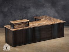 a large wooden counter sitting on top of a floor