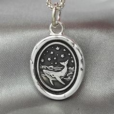 "Whale Ocean Celestial Wax Seal Necklace Pendant, Handmade Sterling Silver, Intaglio Seal Heirloom, Original Design Liliane Ting 072 This wax seal captures the majesty of a whale in its oceanic realm. Carry it as a reminder of the vast depths of life's adventures and the profound beauty that can be found when you venture into the unknown. ♥ About the work: All jewelry are handmade using the original seal made at Liliane Ting Studio located in Murfreesboro, Tennessee.  Made with recycled sterling silver to make our products more sustainable. >>Size: 24 * 22 mm excluding bail  >>Material: Solid Sterling Silver >>Pendant Only Option: You may order \"Pendant Only\".  This charm comes on a 5 mm sterling jump ring that you may thread onto your own necklace chain.  >>Chain Options: The sterling s Whale Ring, Seal Necklace, Wax Seal Necklace, Murfreesboro Tennessee, Whale Necklace, Pewter Pendant, A Whale, Men Jewelry, Silver Work