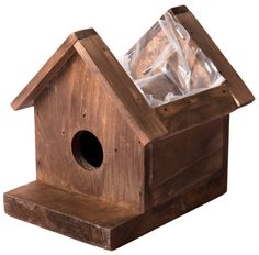 a wooden birdhouse with a plastic bag inside it's roof and window on the outside