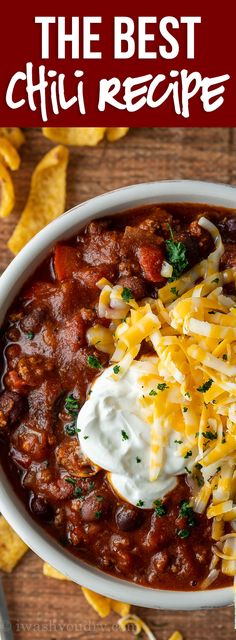 the best chili recipe with cheese and sour cream in a white bowl on a wooden table