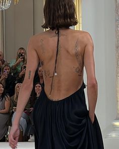 the back of a man in a black dress