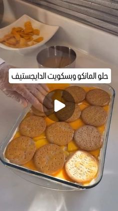 a person placing crackers in a baking dish