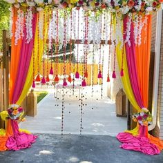 an outdoor ceremony decorated with flowers and garlands