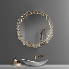 a bathroom with a sink, mirror and towel rack on the wall next to it