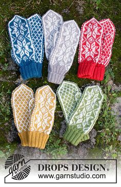 four knitted mittens sitting on top of a green grass covered ground with the words drops design written below them