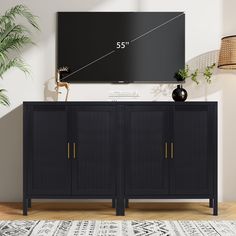 a flat screen tv mounted to the side of a wall next to a black cabinet