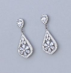 "Elegant and classical 'modern' vintage! Gorgeous rhodium cubic zirconium earrings in a filigree design have the same sensational sparkle as real diamonds. Designed in a style that enhances most facial shapes, you'll find them perfect if you are wanting a sophisticated earring for your wedding day jewels. ★★ We now also make these in clip ons that look identical. Length : approx 1.25\" (3 cm) Set in tarnish resistant 16K rhodium (aka white gold) plate with a nickel free earpost. ★Shopping for yo Formal Bridal Earrings With Cubic Zirconia, Formal Cubic Zirconia Bridal Earrings, Classic Cubic Zirconia Earrings With Elegant Design, Wedding Crystal Diamond Earrings (pierced), Wedding Crystal Diamond Earrings Pierced, Wedding Diamond Crystal Earrings Pierced, Pierced Diamond Crystal Earrings For Wedding, Classic Cubic Zirconia Chandelier Earrings For Anniversary, Silver Drop Earrings With Intricate Design