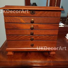 a wooden dresser sitting on top of a table