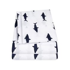 two sheets with black birds on them and white sheets in the same pattern, one is folded