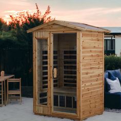 a small wooden sauna sitting on top of a patio