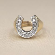 Vintage 14k gold horseshoe ring with approx .55 ctw of round brilliant cut diamonds. White gold topped to accentuate the diamonds. The sides of the band have a brushed finish.  Era: c.1970s Markings: 14k  Materials: 14k gold, .55 ctw diamonds  Ring Size: 8 (comes with free resizing by our jeweler) Weight: 7.1 grams Face measures 16mm x 14.85mm Rise: 4mm Condition: Excellent vintage condition with minor surface wear from age  Shipping is free in the United States Follow us on Instagram @LUXXORVin Diamond Horseshoe Ring For Anniversary, Horseshoe Diamond Ring For Anniversary, Classic Horseshoe Shaped Anniversary Rings, Horseshoe Ring, Hudson Ny, Diamonds Ring, Gold Top, Round Brilliant Cut Diamond, Gold Style