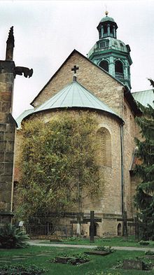 an old church with a cross on the roof