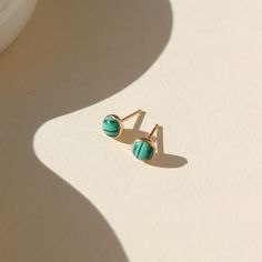 14k gold fill Malachite Studs placed in the sunlight. These Earrings feature Malachite gemstone. Green Dainty Jewelry For Everyday, Dainty Green Jewelry For Everyday, Dainty Green Everyday Jewelry, Dainty Green Round Jewelry, Hypoallergenic 14k Gold Green Jewelry, Hypoallergenic Green 14k Gold Jewelry, Everyday Green Birthstone Jewelry, Green Gemstone Jewelry For Everyday, Everyday Turquoise 14k Gold Jewelry