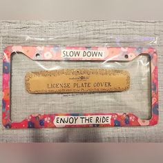 a license plate frame with the words slow down and license plate cover printed on it