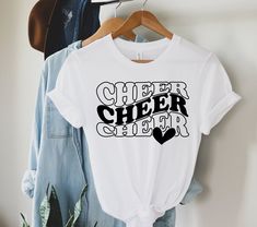 "Welcome to Maddy Paddy Designs Etsy Shop! This listing is for a cheer mom shirt. *If you would like to see the design on a different style shirt, please do not hesitate to ask. I use Bella + Canvas premium t-shirts which have a soft and light feel. They are very comfy and will became your favorite tee to wear. With unisex sizing it's perfect for both men and women. Solid Colors * 100% Cotton Athletic Heather * 90% cotton * 10% polyester Heather * 52% cotton * 48% polyester I suggest that you me Mustang Cheer Shirts, Cheer Tees Shirt Ideas, Mini Cheer Camp Shirts, Cheerleader Tshirt Designs Ideas, Cheerleader Shirt Ideas, School Spirit Cheerleading Short Sleeve Tops, School Spirit Cheerleading Tops With Text Print, Team Spirit Cheerleading Tops With Text Print, Cheerleading Text Print Tops With Team Spirit