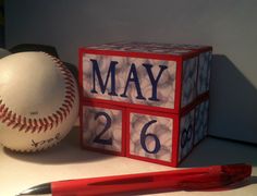 a baseball, ball and pen on a table