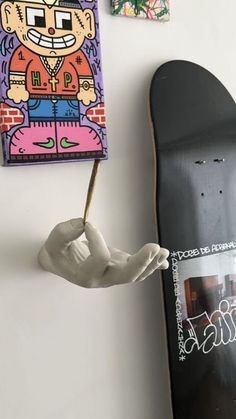 a skateboard is hanging on the wall next to some pictures