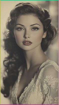 an old photo of a woman with long hair and blue eyes wearing a white dress