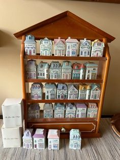 a wooden shelf filled with lots of small houses