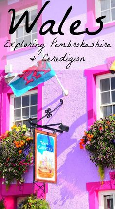 the front of a pink building with flowers and an umbrella on it's side