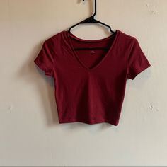 A Slightly Cropped V-Neck Fitted Tee By Wild Fable In A Beautiful Burgundy Color. Size Small. It Is Brand New Never Been Worn, I Ordered Online And Only Wore It To Try It One, Unfortunately The Tags Got Pulled Off While Trying It On So I Can’t Return It As It Was To Small. It’s A Great Tee That Is Super Flattering And Hits All The Right Spots On Your Body. I Know I Reorders A Size Up! Red Fitted V-neck Top, Red Cotton V-neck Crop Top, Red Stretch V-neck T-shirt, Red V-neck Casual T-shirt, Basic V-neck Stretch Crop Top, Spring Casual Low-cut Tops, Casual Low-cut Tops For Spring, Casual Low-cut Spring Tops, Red V-neck Cotton Crop Top