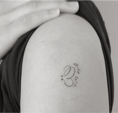 a woman's arm with a tattoo on it that reads 3 and has the number three