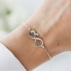 This beautiful dainty sterling silver cat bracelet makes a wonderful gift for someone special! This bracelet features an infinity symbol with a cat shape & a heart - and is presented in a beautiful gift box with your chosen card.  Personalise it with an optional hand-stamped disc or birthstone - it will be attached to the end of the extension chain - it makes the bracelet more unique and special.  ∙  All components made from high-quality 925 sterling silver ∙  Each order comes in a beautiful gift box  ∙  Made with love in Norwich, Norfolk ∙  Delicate personalisation option available S I Z E  Adjustable  (6.7 in to 8.3 in) (17 cm - 21 cm) If you need a smaller size, please send us a message! The bracelet makes a lovely and lasting gift for: celebrating a new pet member of a family, birthday Norwich Norfolk, Cat Bracelet, Gift For Cat Lover, White Jewelry Box, Sterling Silver Cat, Silver Cat, Women Birthday, Infinity Symbol, Beautiful Gif