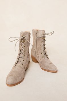 Elevate your shoe game with the Darcy Lace Up Studded Boot. Made of soft tan suede, these almond-toe boots will add a touch of edgy style to any outfit. Featuring gold stud detailing and a side zip closure, these boots are perfect for fashionistas who aren't afraid to stand out. The perfect fall accessory. Fall Beige Suede Lace-up Boots, Fall Suede Lace-up Boots, Beige Suede Lace-up Boots For Fall, Medium Width Suede Lace-up Boots For Fall, Suede Lace-up Boots For Fall, Lace-up Suede Heeled Boots With Reinforced Heel, Chic Suede Lace-up Heeled Boots, Chic Lace-up Suede Heeled Boots, Chic Suede Lace-up Boots With Reinforced Heel