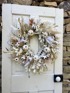 a white door with a wreath on it